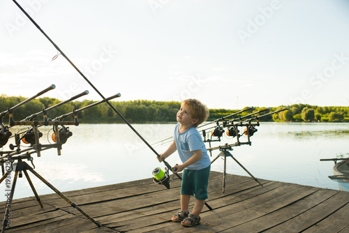 Fototapeta Angling child with fishing rod on wooden pier