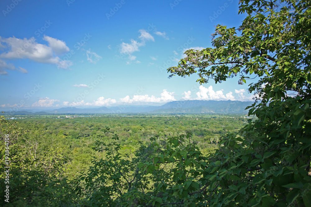 The view from the hill of the Su Taung Pyae Pagoda over the distant green hills and mountains in Myanmar