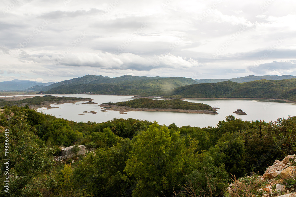 view of a large lake with Islands in Montenegro in the mountains