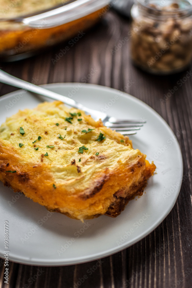 Shepherd's pie on a wooden background Shepherd's pie on a wooden background