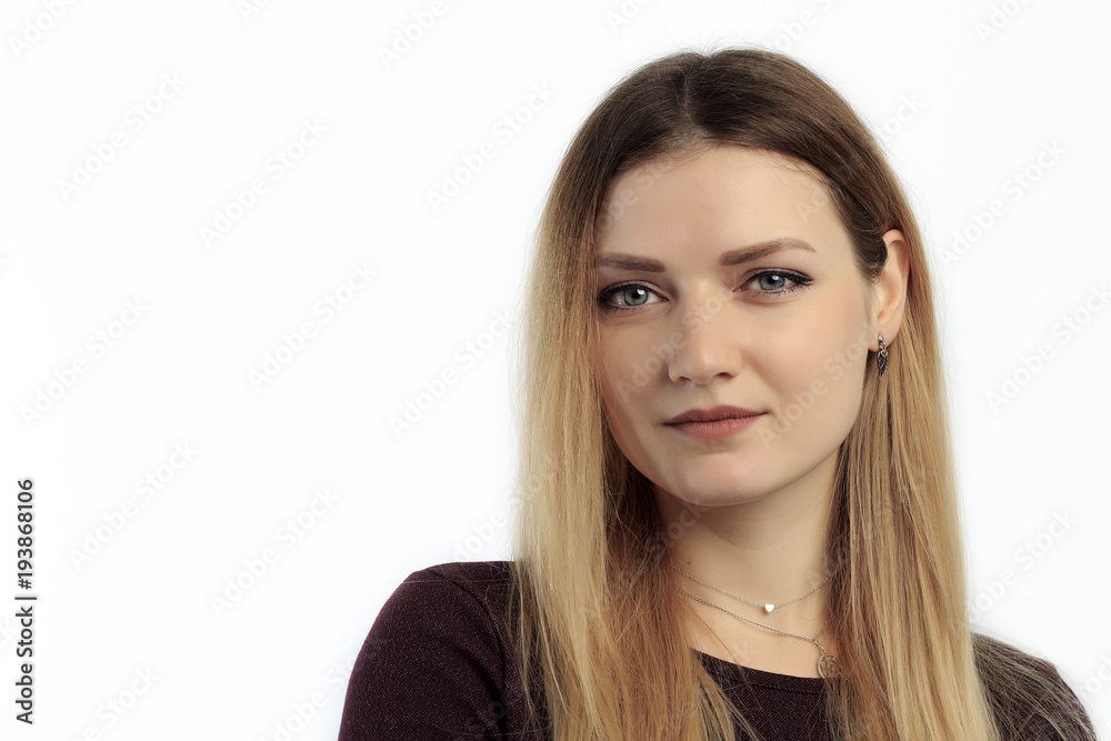Portrait of young European female with healthy clean skin and blue eyes wearing casual top looking at camera with serious expression. Portrait of young European female with healthy clean skin and blue eyes wearing casual top looking at camera with serious expression.