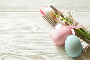 Easter laying table appointments, table setting options. Silverware, tableware items with festive decoration. Fork, knife and flowers. Happy easter holiday.