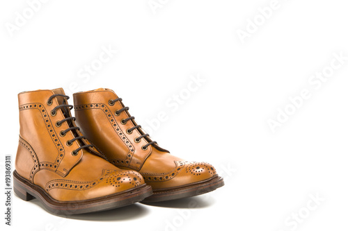 Footwear Ideas. Premium Tanned Brogue Derby Boots Made of Calf Leather with Rubber Sole. Isolated Over Pure White Background
