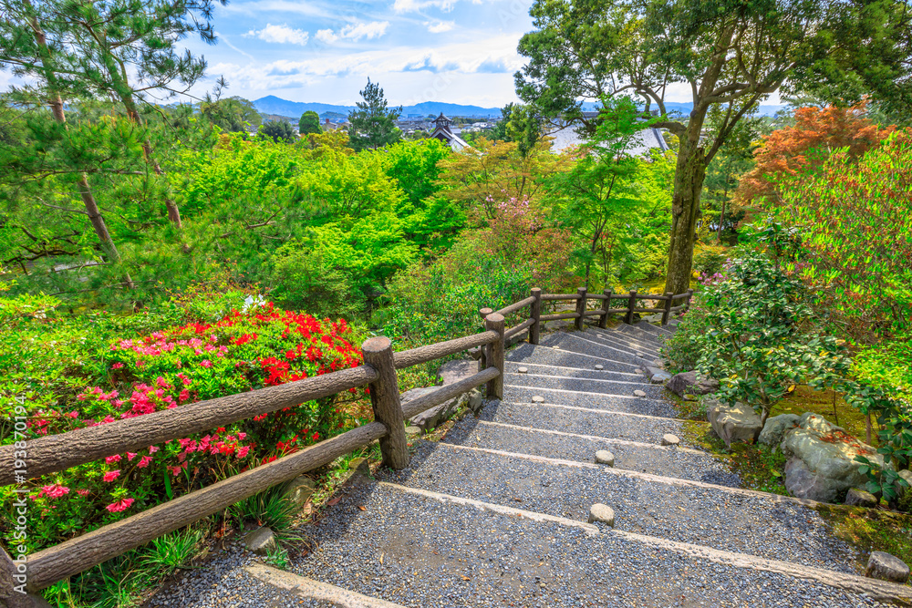 Arashiyama city panorama and aerial view of Tenryu-ji Zen Temple on the hill above the temple in the mountains on western outskirts of Kyoto, Japan. Garden path of a hundred flowers or Hyakka'en.