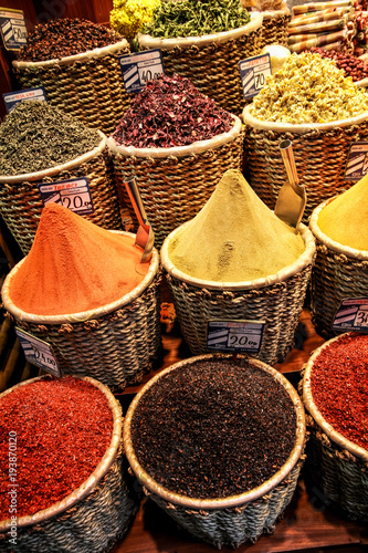 A close-up of oriental spices poured into wicker baskets in the Turkish bazaar
