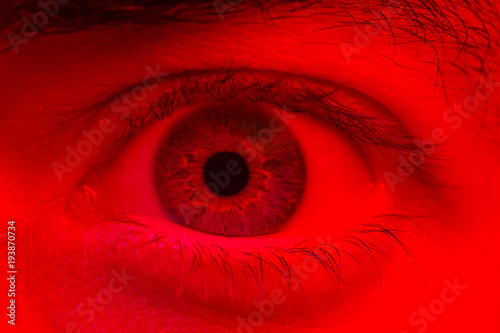 Macro on man eye expressing shocked surprise and fear expression