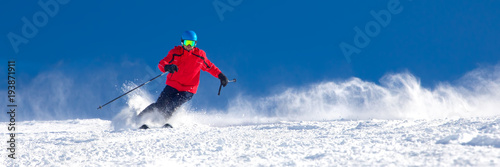 Man skiing on the prepared slope with fresh new powder snow in Tyrolian Alps, Zillertal, Austria