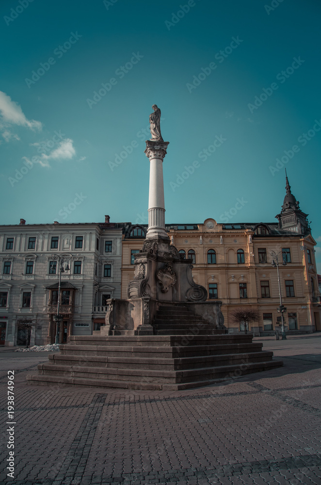 Obraz premium A horizontal color image of Old Main Square with town halls, clock tower and St. Francis Xavier Cathedra. Captured Banska Bystrica, Slovakia