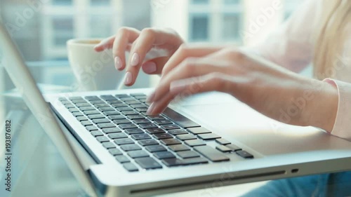 Close up of female hands using laptop computer, indoors.