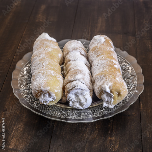 Elegant french cream horn pastries on decorative plate