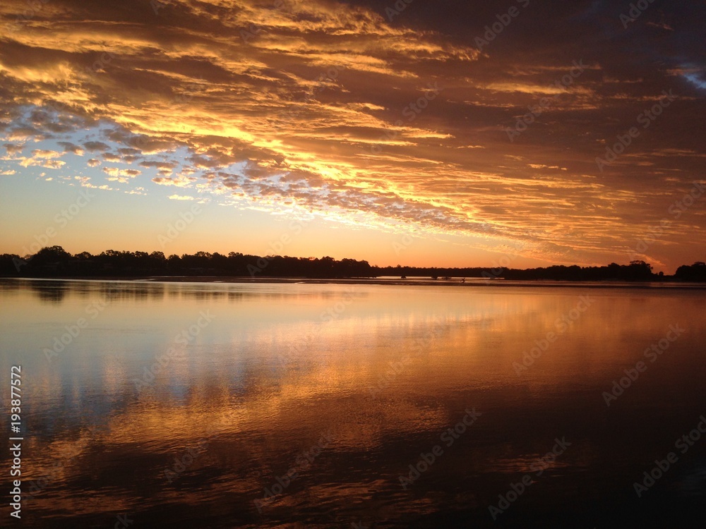 Vivid Colourful sunset reflecting on the beach