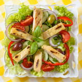 Chicken salad on the plate. Grilled chicken meat with tasty selection of vegetables.