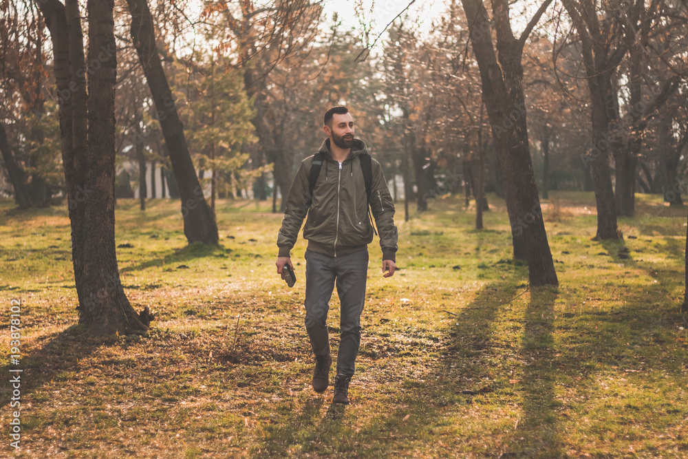 young man with beard in forest. Exploring the forest