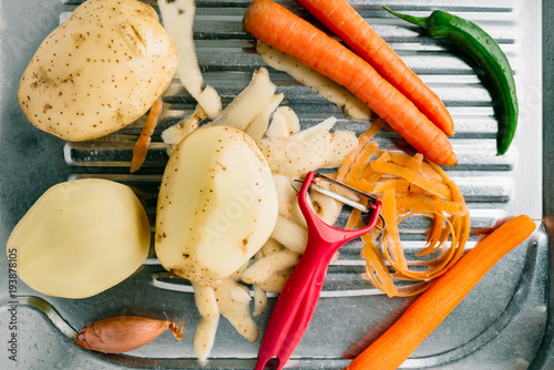 Spring vegetables, start preparing food. The peeled potatoes and carrots. Homemade food preparation.
