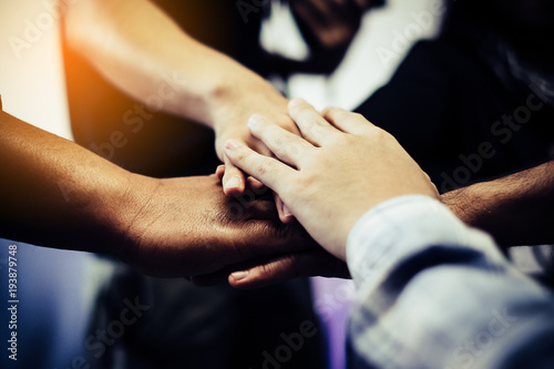 Business teamwork. Business man coworkers with joined hands together represent unity. Dedication and teamwork lead to success © doidam10