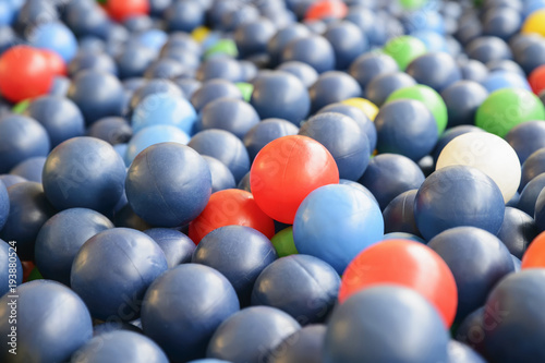 Background texture of multi-colored plastic balls on the playground.