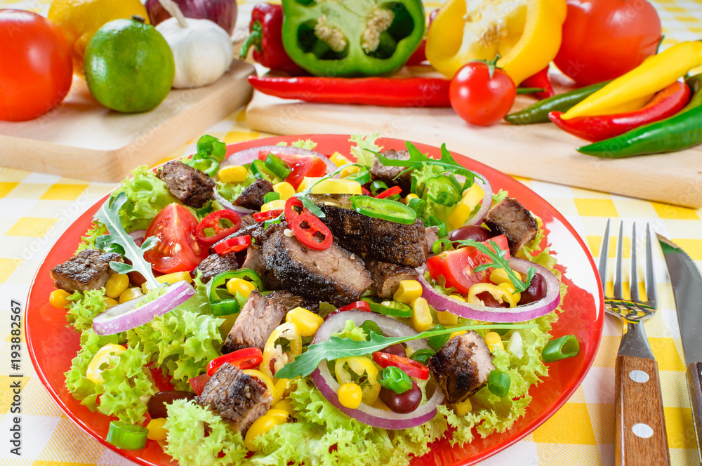 Mexican spicy beef salad on the plate. Grilled beef meat with tasty selection of vegetables. Mexican spicy beef salad on the plate. Grilled beef meat with tasty selection of vegetables.