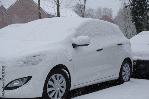 White car covered with snow