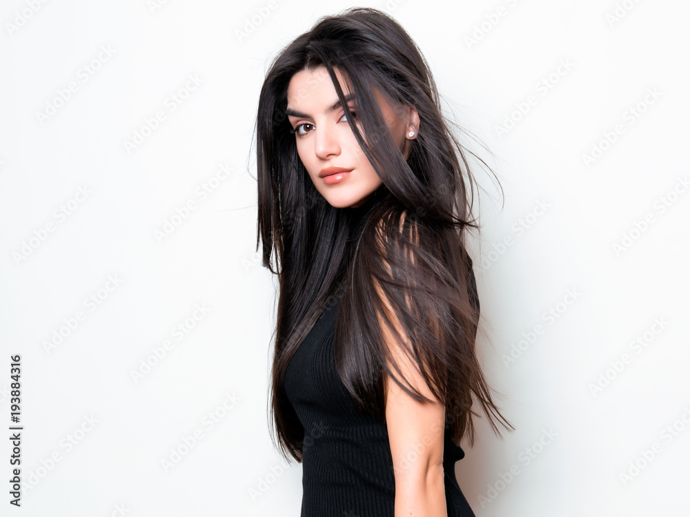 beautiful young woman with long black hair posing in black knit dress beautiful young woman with long black hair posing in black knit dress