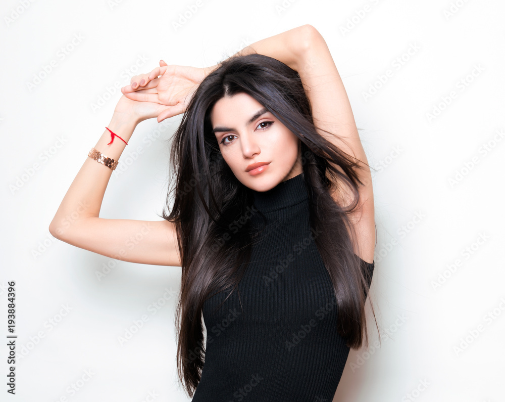 beautiful young woman with long black hair posing in black knit dress beautiful young woman with long black hair posing in black knit dress