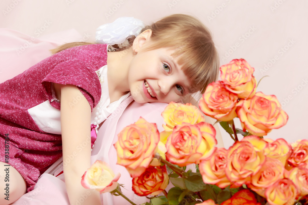 Little girl with a bouquet of tea roses.