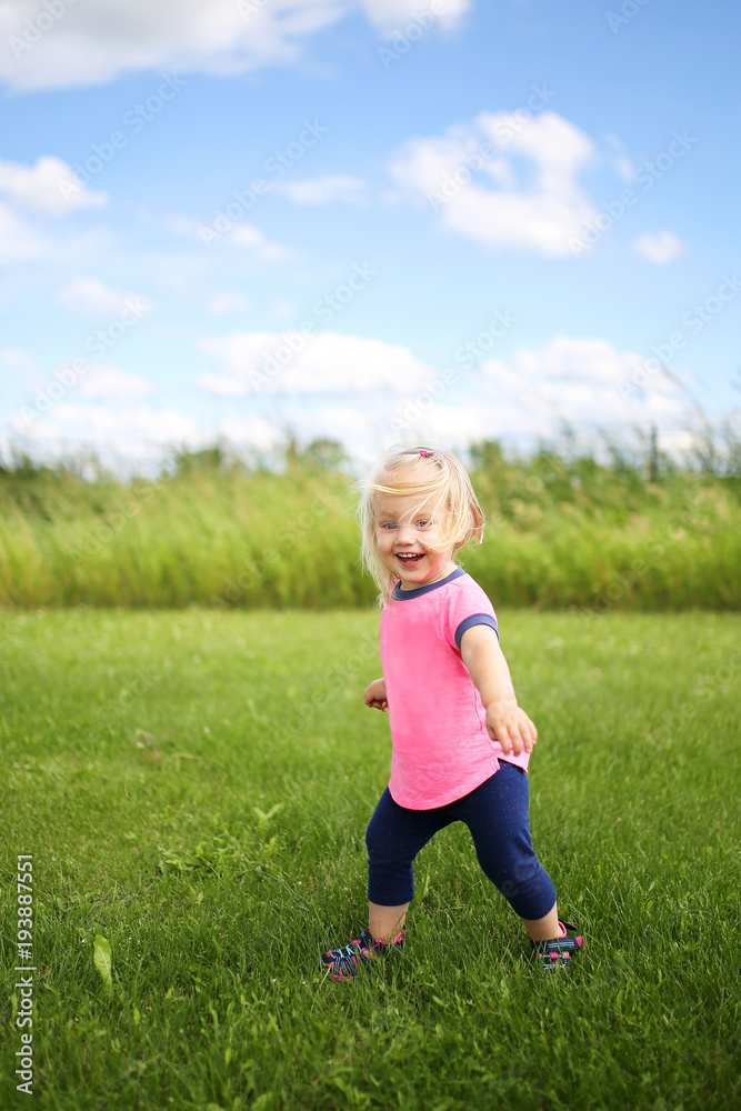 Cute Baby Toddler Girl Runing OUtside in the Grass on a Summer Day Cute Baby Toddler Girl Runing OUtside in the Grass on a Summer Day