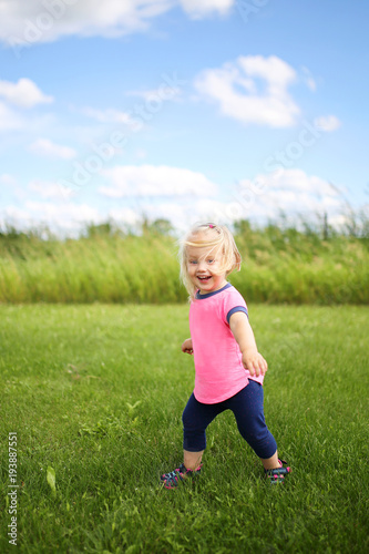Cute Baby Toddler Girl Runing OUtside in the Grass on a Summer Day