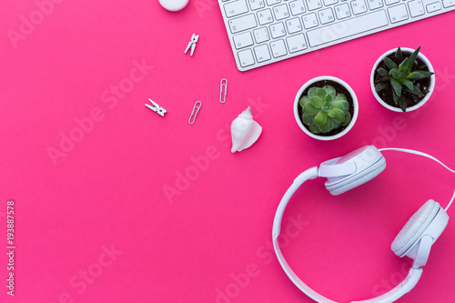 Flat Lay of creative desktop, keyboard, succulent and headphones. Mock up, flat lay, pastel background