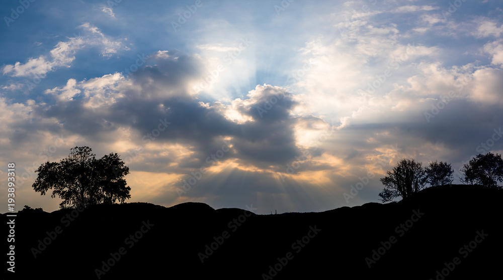 Panoramic sunset with clouds in the twilight sky with mountain silhouette