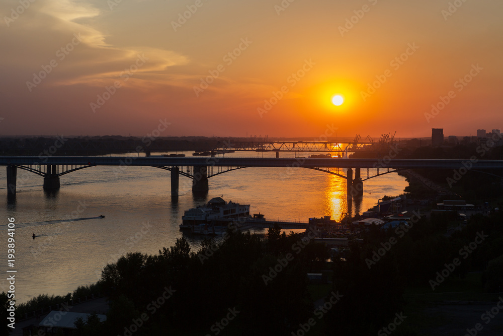 Beautiful sunset over the Octyabrsky bridge across river Ob in Novosibirsk