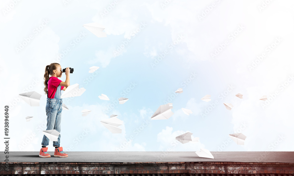 Concept of careless happy childhood with girl of school age looking in future Concept of careless happy childhood with girl of school age looking in future