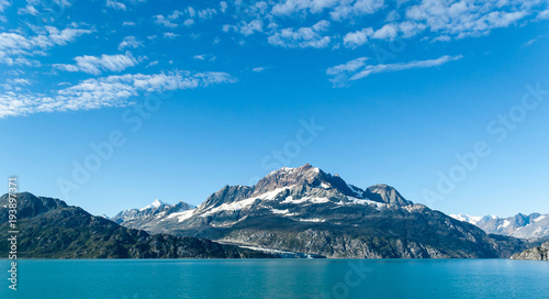 Photography Snow-capped mountain peak in Glacier Bay National Park with sky and clouds