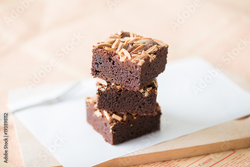 Close up sweet chocolate brownie with almond topping  selective focus