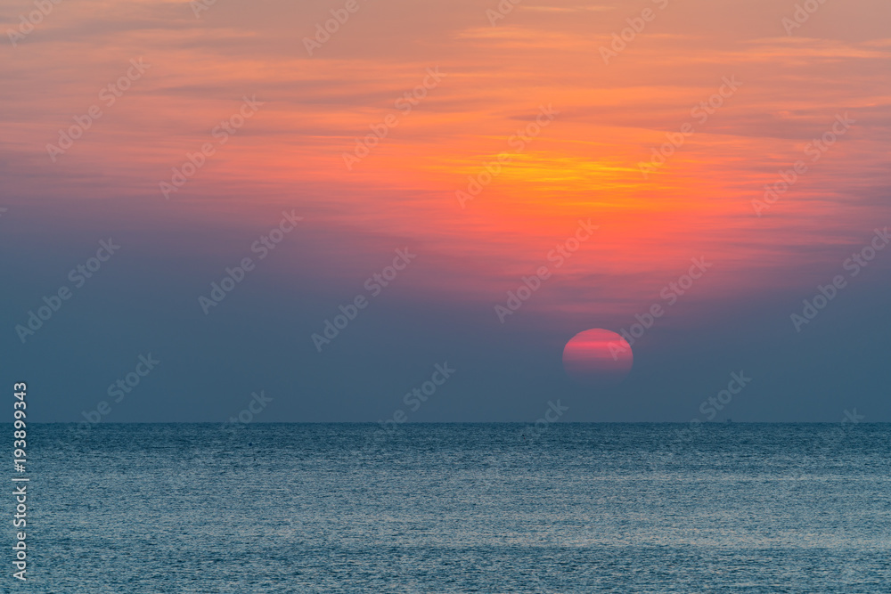 Calm sea with orange sky during sunset