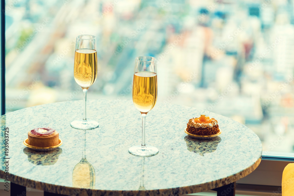 Gourmet pastries with white wine in a room high above the city