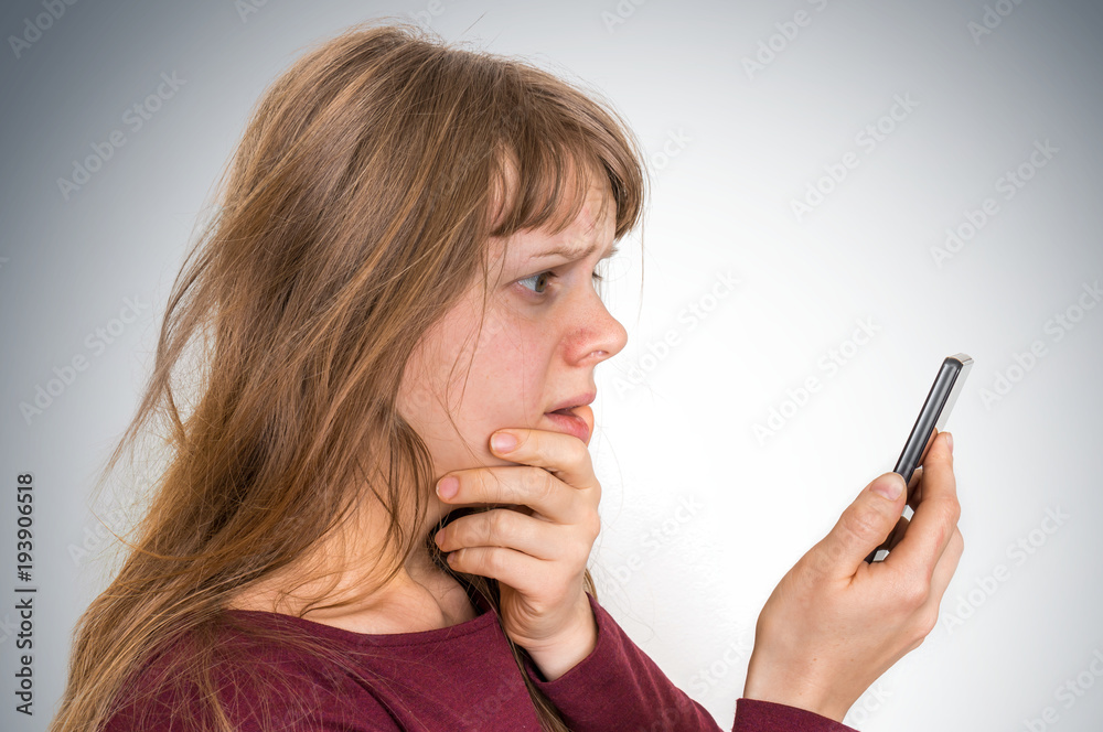 Sad woman with mobile phone - bad news concept Sad woman with mobile phone - bad news concept