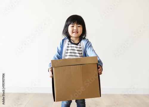 Asian kid helping move now house
