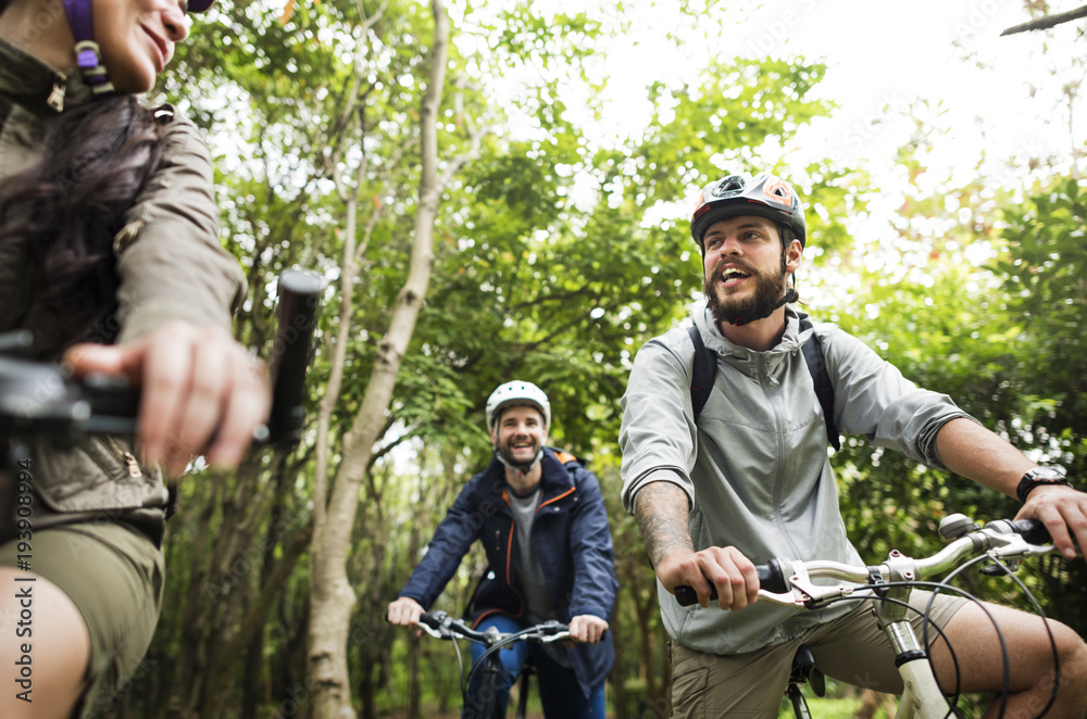 Fototapeta premium Group of friends ride mountain bike in the forest together