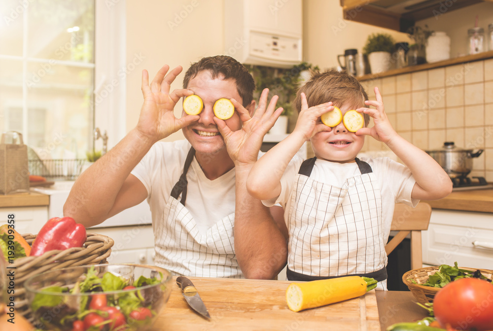 Father is cooking with his son Father is cooking with his son