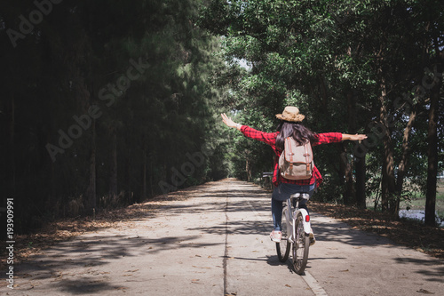 Happy woman backpacker with white bicycle in nature background, Relax time on holiday travel concept color of hipster style selective and soft focus