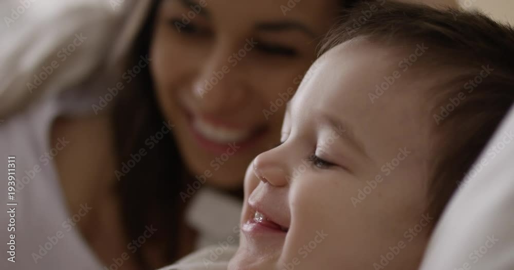 Smiling mother and toddler - rack focus between mother and son - close up Smiling mother and toddler - rack focus between mother and son - close up