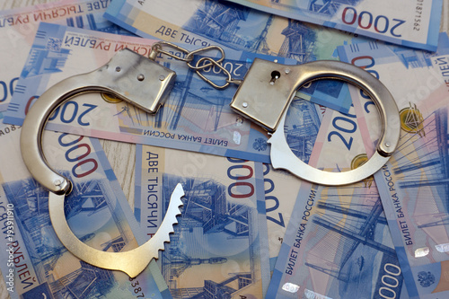 The handcuffs are on the Russian banknotes .