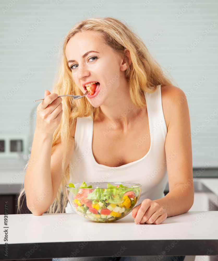 Young woman preparing vegetable salad Young woman preparing vegetable salad