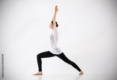 Woman doing yoga exercise. In warrior possition. photo