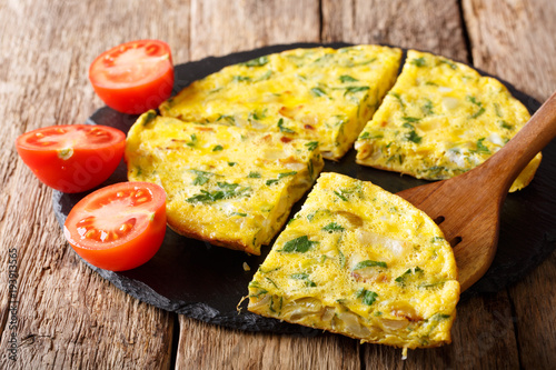 Homemade sliced scrambled eggs with greens, onions closeup. horizontal photo