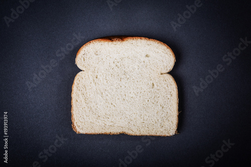 Canvas One slice of white sandwich bread on a gray background