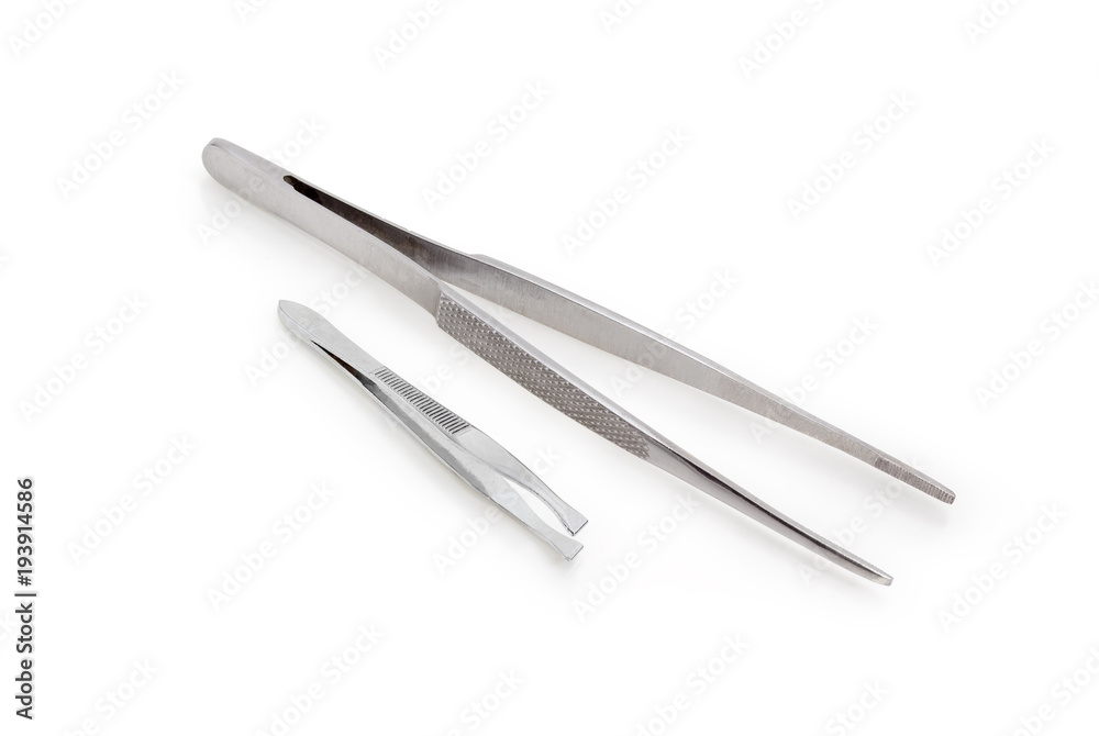 Two different steel tweezers on a white background Two different steel tweezers on a white background