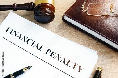Document with title Financial penalty on a desk.