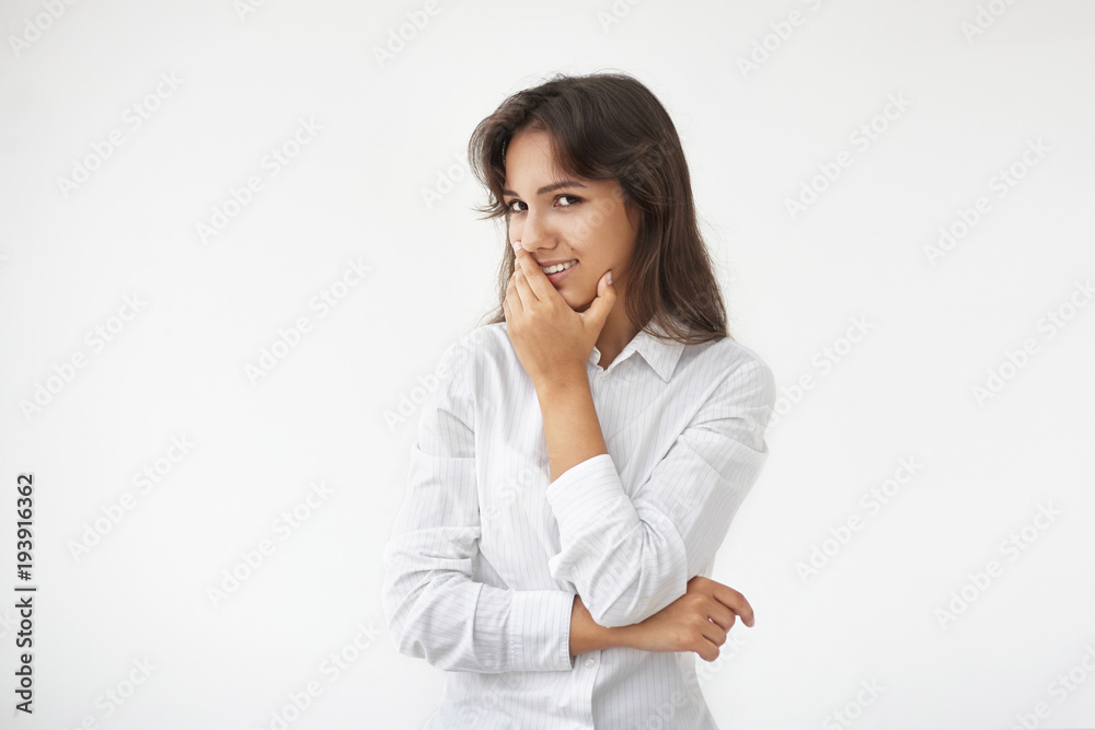 Peolple, job and employment concept. Charming talented young mixed race female wearing white formal blouse smiling happily after successful job interview, posing against blank studio wall background Peolple, job and employment concept. Charming talented young mixed race female wearing white formal blouse smiling happily after successful job interview, posing against blank studio wall background