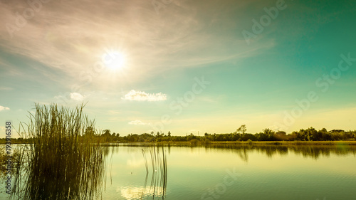 Sunset with blue sky over lake vintage tone